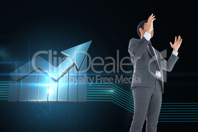 Composite image of businessman with arms raised