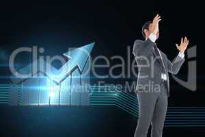 Composite image of businessman with arms raised