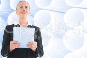 Composite image of businesswoman holding tablet