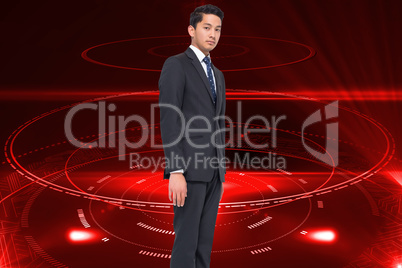 Composite image of frowning businessman looking at camera