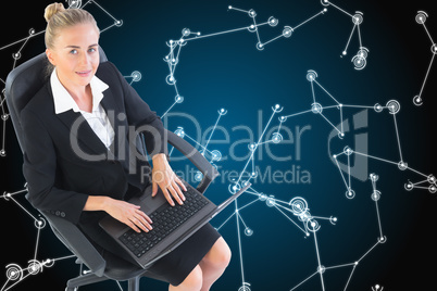 Composite image of businesswoman sitting on swivel chair with la