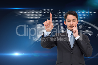 Composite image of thoughtful asian businessman pointing