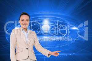Composite image of smiling asian businesswoman pointing