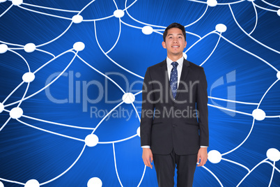 Composite image of smiling businessman looking up
