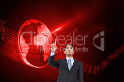 Composite image of serious asian businessman pointing