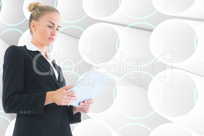 Composite image of businesswoman holding tablet