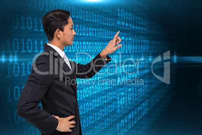 Composite image of unsmiling asian businessman pointing