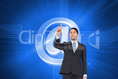 Composite image of serious asian businessman pointing