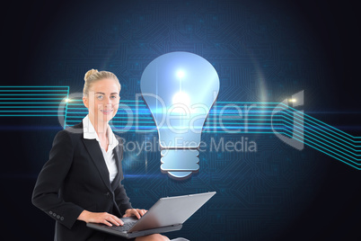 Composite image of businesswoman using laptop