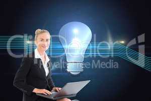 Composite image of businesswoman using laptop