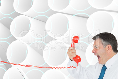 Composite image of businessman screaming directly into the hands