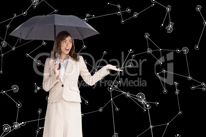 Composite image of elegant businesswoman holding black umbrella