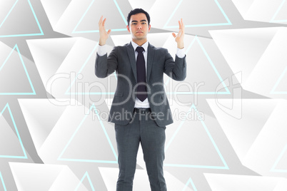 Composite image of unsmiling businessman with arms raised
