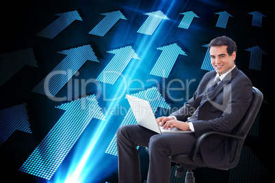 Composite image of young businessman sitting on an armchair work