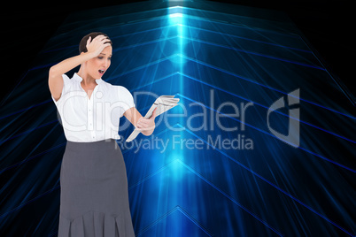 Composite image of surprised classy businesswoman holding newspa