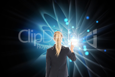 Composite image of businesswoman pointing somewhere