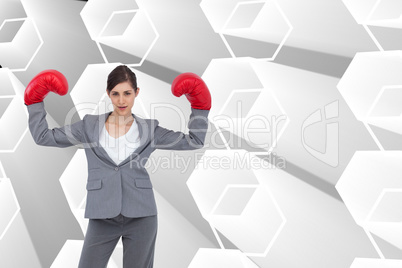 Composite image of businesswoman with boxing gloves