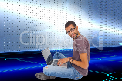 Composite image of man wearing glasses sitting on floor using la