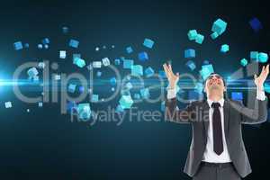 Composite image of happy  businessman with arms raised