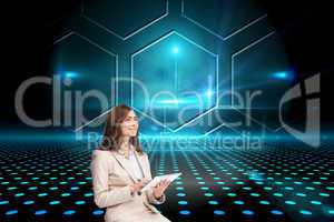 Composite image of businesswoman holding tablet and looking up