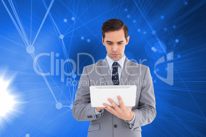 Composite image of businessman holding a tablet computer