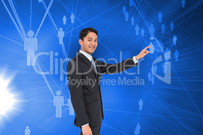 Composite image of smiling asian businessman pointing