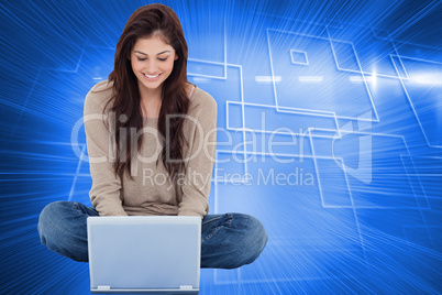 Composite image of brunette sitting on floor using laptop