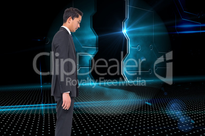 Composite image of unsmiling businessman looking down