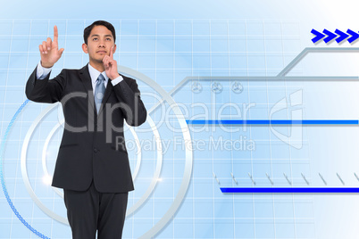 Composite image of thoughtful asian businessman pointing