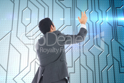 Composite image of businessman with arms raised