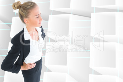 Composite image of businesswoman standing with hands on hips