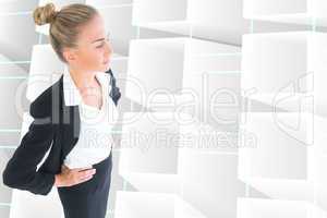 Composite image of businesswoman standing with hands on hips