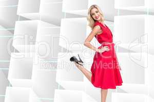 Composite image of smiling blonde standing hands on hips