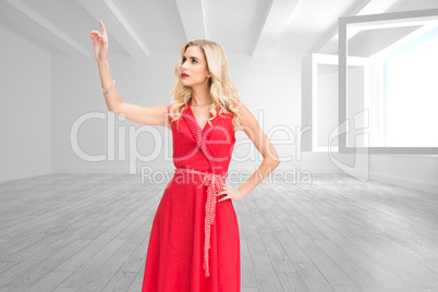 Composite image of elegant blonde standing pointing