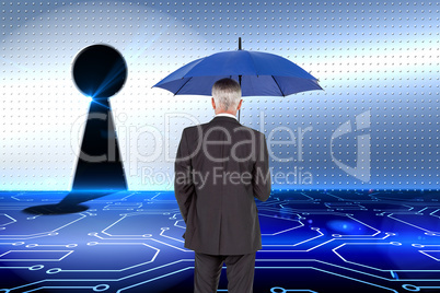 Composite image of businessman holding umbrella