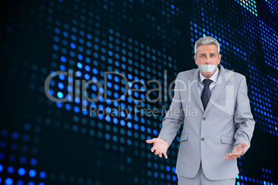 Composite image of businessman gagged with adhesive tape on mout