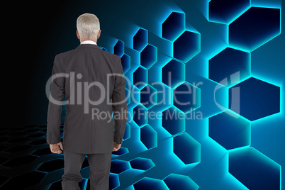 Composite image of businessman walking away from camera