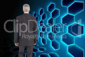 Composite image of businessman walking away from camera