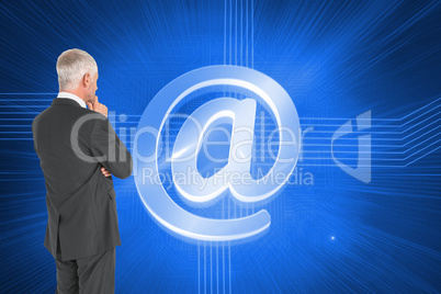 Composite image of thoughtful businessman standing back to camer