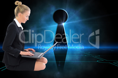 Composite image of businesswoman using laptop