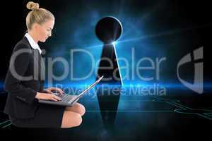 Composite image of businesswoman using laptop