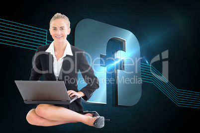 Composite image of businesswoman using laptop