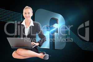 Composite image of businesswoman using laptop