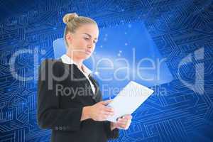 Composite image of businesswoman holding tablet