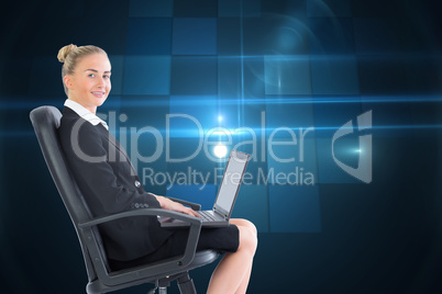 Composite image of businesswoman sitting on swivel chair with la