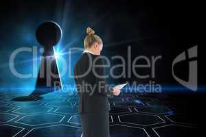 Composite image of businesswoman holding new tablet