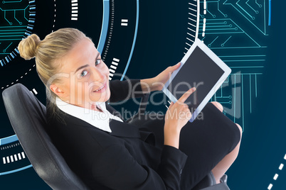 Composite image of businesswoman sitting on swivel chair with ta