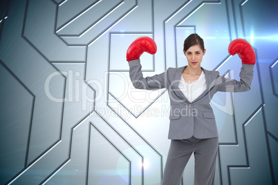 Composite image of businesswoman with boxing gloves