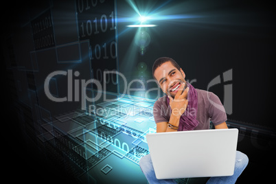 Composite image of thinking man sitting on floor using laptop an