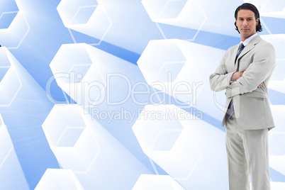 Composite image of serious office worker posing with the arms cr